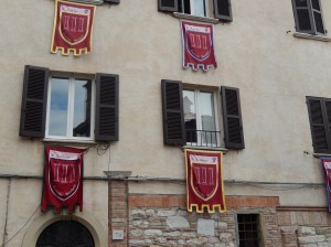 A typical window in Gubbio, dressed in flags