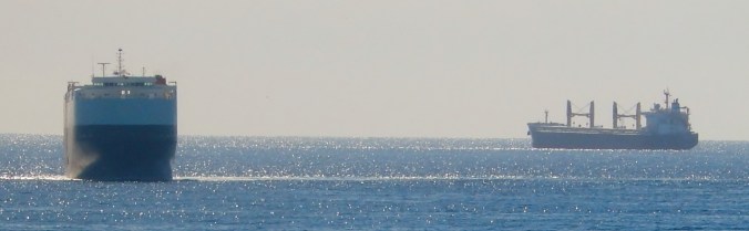 Car ship headed directly our way, while a tanker bobs at anchor