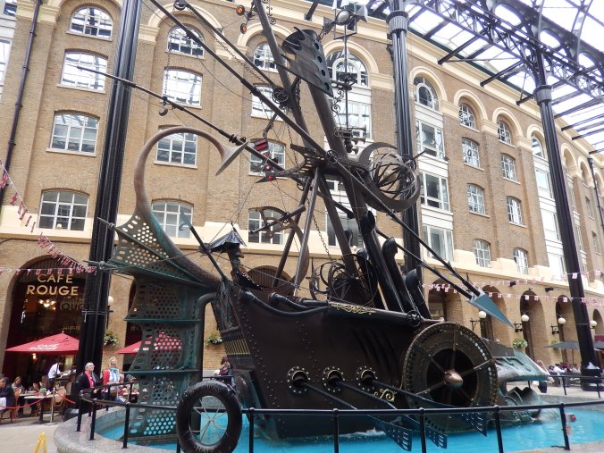 I loved this Sculpture which decorated a courtyard of a restored warehouse along the Thames east London area. Reminiscent of something from a Jules Verne novel. Part boat, part carriage, made with "found" objects such as an old shower head